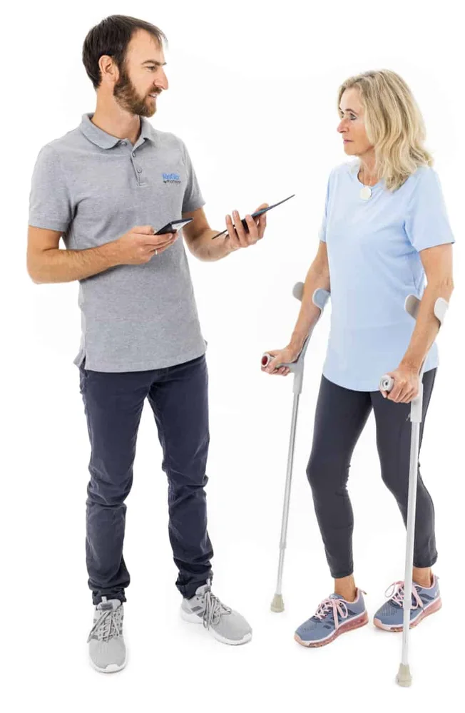 Moticon ReGo Sensor Insoles - Moticon manufacturer photograph showing a clinician holding a physical ReGo insole during a consultation.
